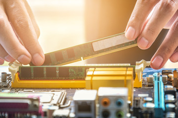 Hand putting to RAM random access memory on mainboard