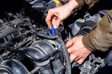 man's hands closeup and car parts, car repair