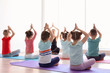 © New Africa - Little children and their teacher practicing yoga in gym