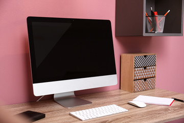 Comfortable workplace with computer on desk in home office