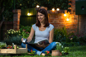 Beautiful mid age woman doing some gardening in her backyard