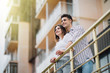 © F8  \ Suport Ukraine - Lovely happy couple relax and have fun at balcony in their new home apartment