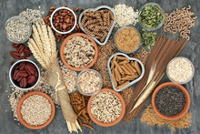 High Fibre Healthy Food Concept With Fresh Whole Wheat Pasta, Cereals, Grains, Seeds, Nuts And Wheat Sheaths. Foods High In Omega 3, Antioxidants And Vitamins. Rustic Background On Marble, Top View.