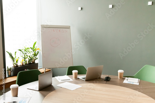 Conference Table With Laptops And Chairs In Empty Meeting