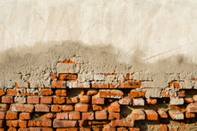 Partly Plastered Old Brick Wall