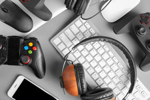 Gamepads, Mice, Headphones And Keyboard On Table