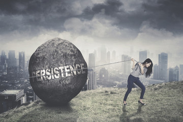 Wall Mural - Young businesswoman pulling persistence word