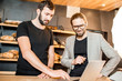 © rh2010 - Businessmen working with laptop at the bakery shop