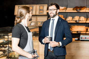 Wall Mural - Businessman with barista in the shop