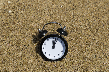 clock on the sand in the beach. holiday time concept for agency. 