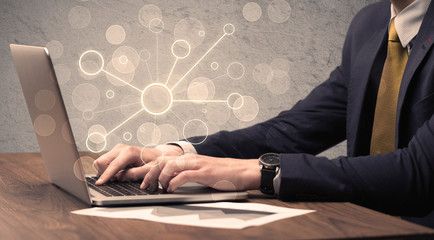 Wall Mural - An office salesman in elegant suit working on a scientific project with the help of a laptop concept