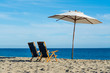 Beach chairs and parasol in Malibu shore