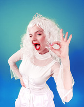 Portrait Of Funny Girl In Blonde Wig Show OK. Studio Shot.