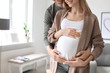 © New Africa - Young pregnant woman with her husband at home