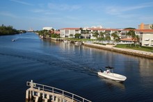Boats Approach The Intracoastal Waterway Bridge Just North Of Hillsboro Blvd. In Deerfield Beach, Florida In A Bright Sunny Afternoon With The Boca Raton Hotel And Resort In The Background