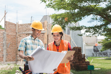 two construction worker standing in front of the building site