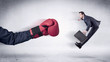 © ra2 studio - Huge Boxing Gloves punches innocent businessman concept