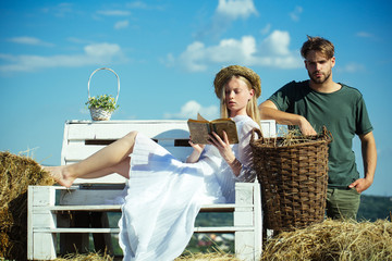 Sticker - Girlfriend and boyfriend date outdoor. Woman bride in wedding dress relax on bench. Sensual woman read book for man. Couple in love on vacation. Family enjoy summer nature