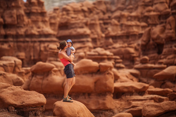 Poster - A mother and her baby son visit Goblin valley state park in Utah, USA