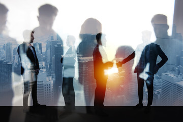 Canvas Print - Handshaking business person in office. concept of teamwork and partnership. double exposure