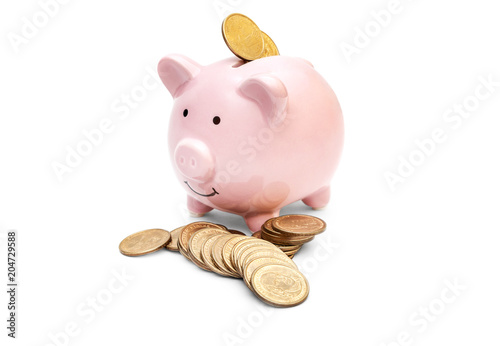 Fotografía Piggy bank with scattered coins on white.