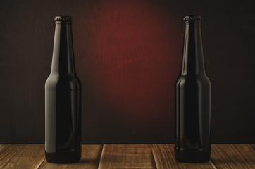 Wall Mural - two black bottle of beer on a red background of a wooden shelf/two black bottle of beer on a red background of a wooden shelf. Selective focus and copyspace