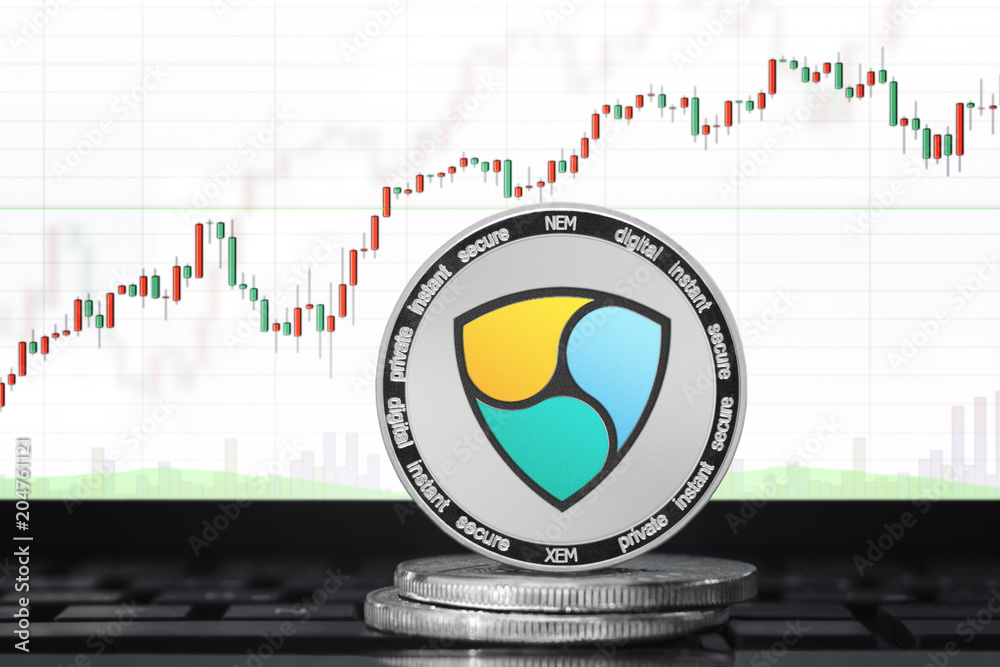 NEM (XEM) cryptocurrency; physical concept NEM coin on the background of the chart