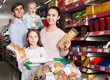 © JackF - parents with two kids choosing biscuits in store