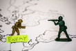 © disha1980 - Plastic toy soldiers are on the world map.  Stand opposite each other.