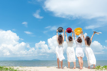 Smiling Group Woman Wearing Fashion White Dress Summer Walking On The Sandy Ocean Beach, Beautiful Blue Sky Background.  Happy Woman Enjoy And Relax Vacation. Lifestyle And Travel Concept
