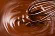 © Subbotina Anna - Chocolate. Mixing melted dark chocolate with a whisk. Closeup of liquid hot chocolate swirl. Confectionery