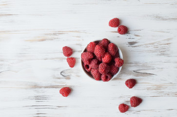 Raspberries on rustic wooden background