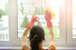 Spring-cleaning and window cleaning. Housewife washes windows with a professional household chemicals.