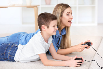 Canvas Print - Young woman playing video games with her son at home