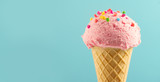 Ice cream. Strawberry or raspberry flavor icecream in waffle cone over blue background. Sweet dessert decorated with colorful sprinkles closeup