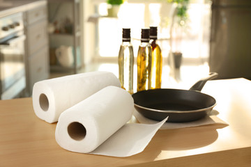 Wall Mural - Rolls of paper towels and frying pan on kitchen table