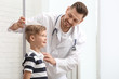 © New Africa - Doctor measuring little boy's height in hospital