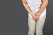 © New Africa - Young man with urological problems suffering from pain on grey background