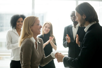 Wall Mural - boss handshaking rewarding motivating successful female employee congratulating with promotion, appr