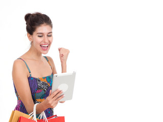 Picture showing pretty woman shopping online with smart tablet.Portrait of young happy smiling woman with shopping bags.