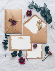 Poster - Mock up creative wedding invitation set with eucalyptus branch  on linen background. Top view, flat lay