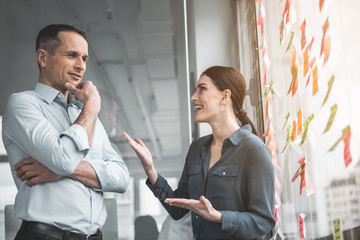 Poster - Outgoing woman and cheerful male telling together. She gesticulating hands. Friendly professional communication concept