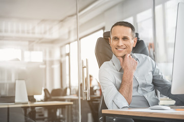 Poster - Portrait of beaming male thinking while having job with digital device. Glad worker concept