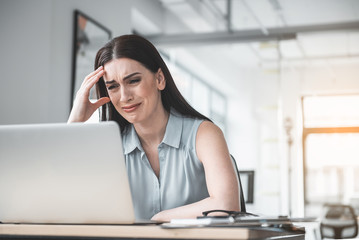Poster - Portrait of crying girl watching at digital device while having job in office. Big trouble during labor concept