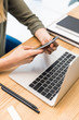 © LIGHTFIELD STUDIOS - cropped shot of businesswoman using smartphone at workplace with laptop