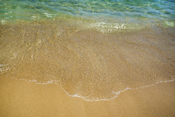 Wall Mural - Soft wave of the sea on the sandy beach. Vacation, holiday background.