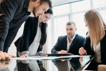 brainstorming. briefing meeting. business discussion. team of managers or executives thinking over a strategy or company development and studying information