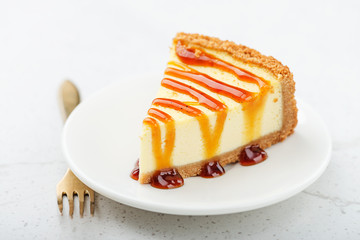 Slice of cheesecake with caramel sauce.