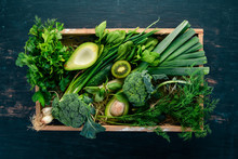 Fresh Green Vegetables And Fruits In A Wooden Basket. Healthy Food. Top View. Copy Space.