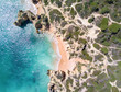 Aerial view of tropical sandy beach, cliffs and ocean.